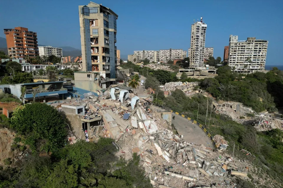 <em>This aerial view shows collapsed buildings in Catia La Mar, La Guaira state, Venezuela, on June 27, 2026, following earthquakes that struck the region. (Photo by Federico PARRA / AFP via Getty Images)</em>