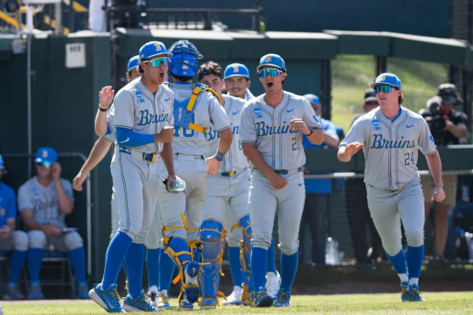 UCLA Bruins runs out of the dugout in celebration after an inning during an NCAA regional championship elimination game between the Saint Mary's College Gaels and UCLA Bruins on May 31, 2026 at Jackie Robinson Stadium in Los Angeles Calif.