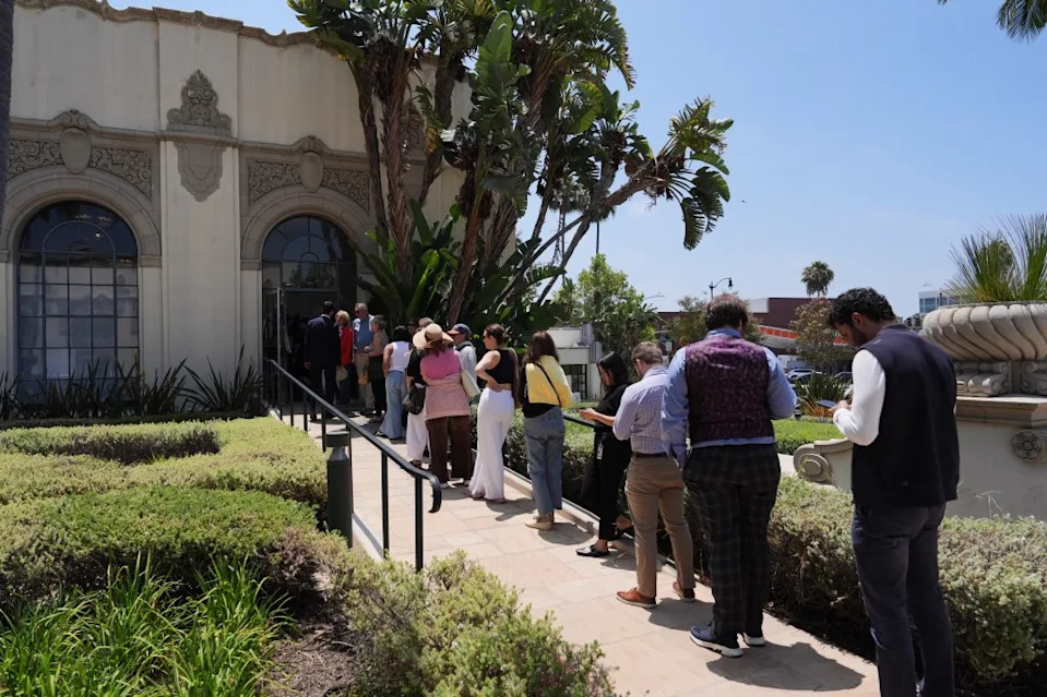 Voters line up to cast their ballots outside a voting center during the California primary election. AP Photo/Jae C. Hong