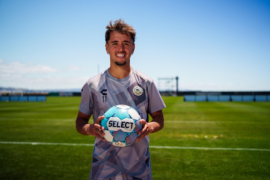 Jesus De Vicente of the Oakland Roots soccer club poses with a ball after training