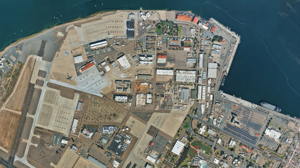 aerial view of an urban area with industrial zones and a portion of an airport