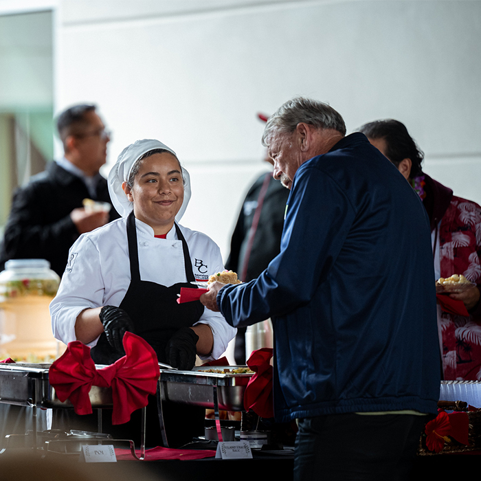 BC food server giving food to an attendee