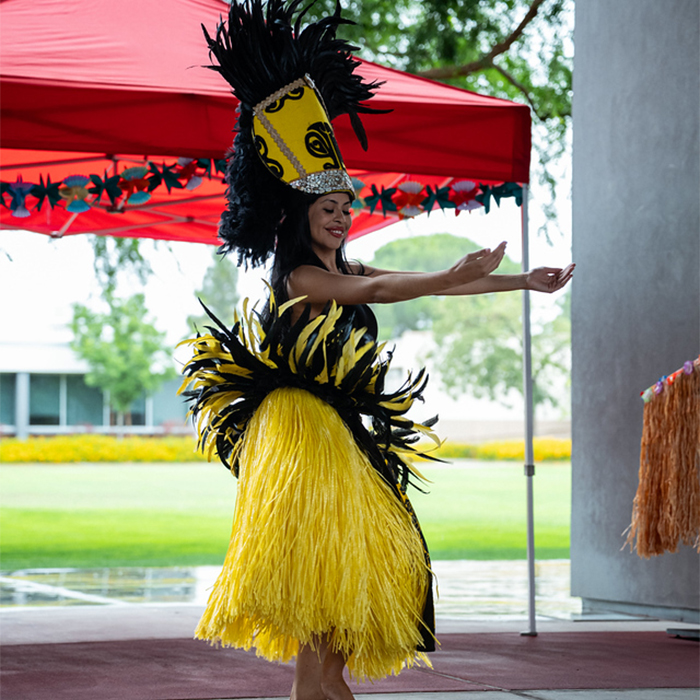 dancer performing while wearing bright yellow outfit