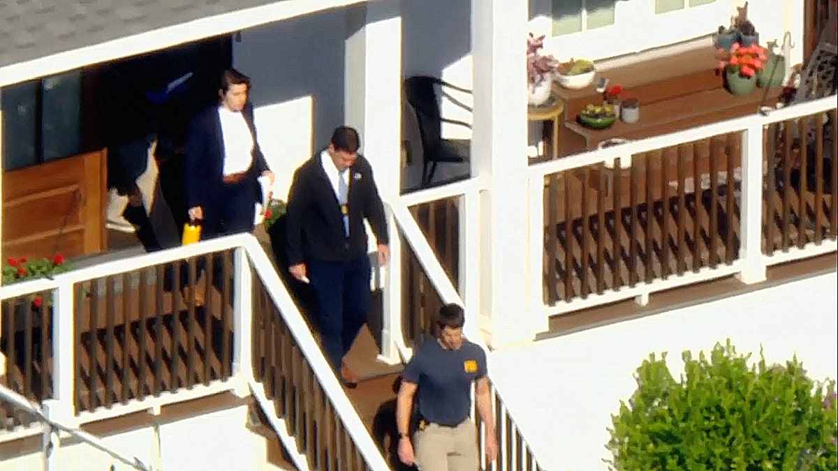 FBI agents conducting a search warrant at a home in San Pedro