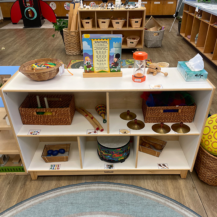shelf filled with musical instruments like cymbals and percussion