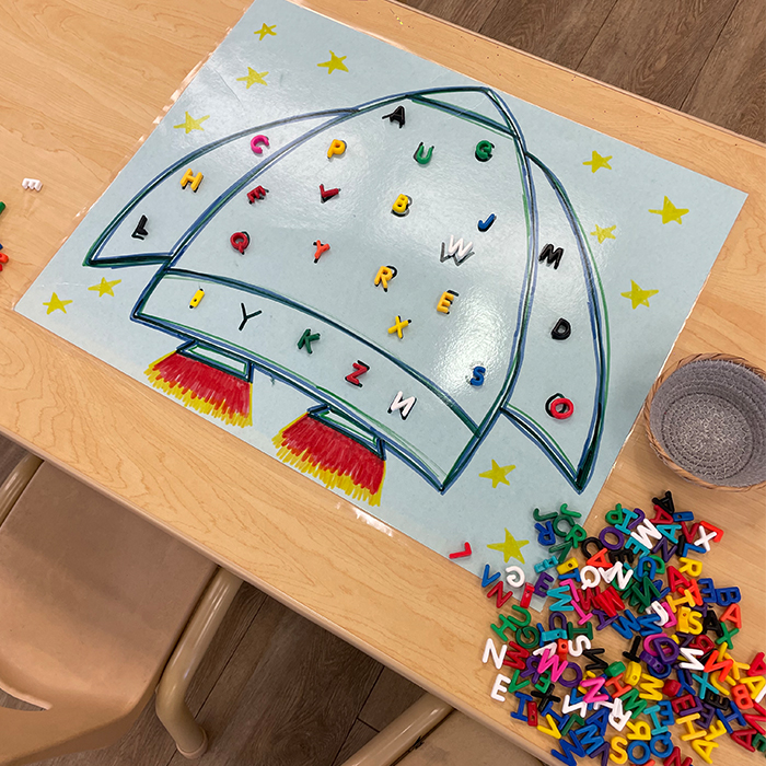 game with a rocketship and movable alphabet letters