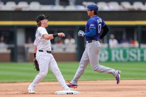 Dodgers two-way player Shohei Ohtani (17) gets tagged out by White Sox second baseman Chase Meidroth (10) in a double play during the first inning at Rate Field Sunday June 14, 2026 in Chicago. (Armando L. Sanchez/Chicago Tribune)