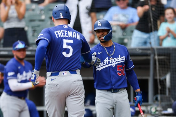 Dodgers first baseman Freddie Freeman (5) celebrates with Dodgers shortstop Mookie Betts (50) after hitting a solo-homer during the first inning against the White Sox at Rate Field Sunday June 14, 2026 in Chicago. (Armando L. Sanchez/Chicago Tribune)