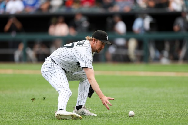 White Sox pitcher Erick Fedde (47) reaches for a ball from Dodgers shortstop Mookie Betts (50) before Betts reached first during the fourth inning at Rate Field June 14, 2026 in Chicago. (Armando L. Sanchez/Chicago Tribune)