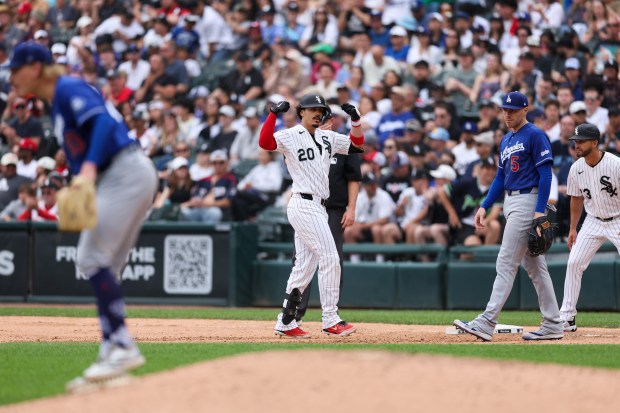 White Sox third baseman Miguel Vargas (20) gestures near first base after hitting a single during the sixth inning against the Dodgers at Rate Field June 14, 2026 in Chicago. (Armando L. Sanchez/Chicago Tribune)
