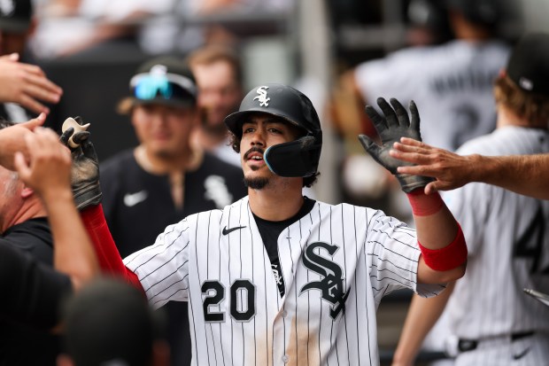 White Sox third baseman Miguel Vargas (20) celebrates in the dugout after scoring off a RBI double from White Sox designated hitter Andrew Benintendi (23) during the sixth inning against the Dodgers at Rate Field June 14, 2026 in Chicago. (Armando L. Sanchez/Chicago Tribune)