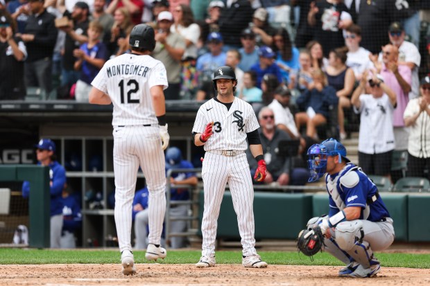 White Sox shortstop Colson Montgomery (12) celibates with White Sox designated hitter Andrew Benintendi (23) after hitting a two-run homer during the sixth inning against the Dodgers at Rate Field June 14, 2026 in Chicago. (Armando L. Sanchez/Chicago Tribune)