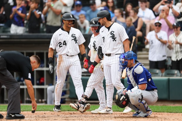 White Sox second baseman Chase Meidroth (10) celebrates with White Sox outfielder Braden Montgomery (24) and White Sox first baseman Jacob Gonzalez (7) after hitting a two-run homer during the sixth inning against the Dodgers at Rate Field June 14, 2026 in Chicago. (Armando L. Sanchez/Chicago Tribune)