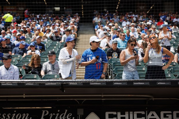 Dodgers and White Sox fans stand near the Dodgers dugout before the first inning at Rate Field Sunday June 14, 2026 in Chicago. (Armando L. Sanchez/Chicago Tribune)