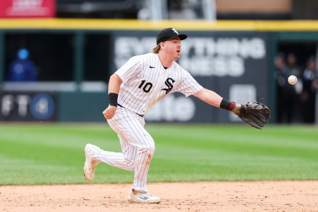 White Sox second baseman Chase Meidroth (10) tosses the ball to White Sox shortstop Colson Montgomery (12) to tag out Dodgers two-way player Shohei Ohtani (17) at second during the ninth inning at Rate Field June 14, 2026 in Chicago. (Armando L. Sanchez/Chicago Tribune)