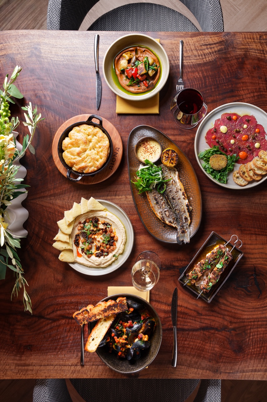 A table of live-fire Mediterranean food at Aiona in Downtown Sacramento