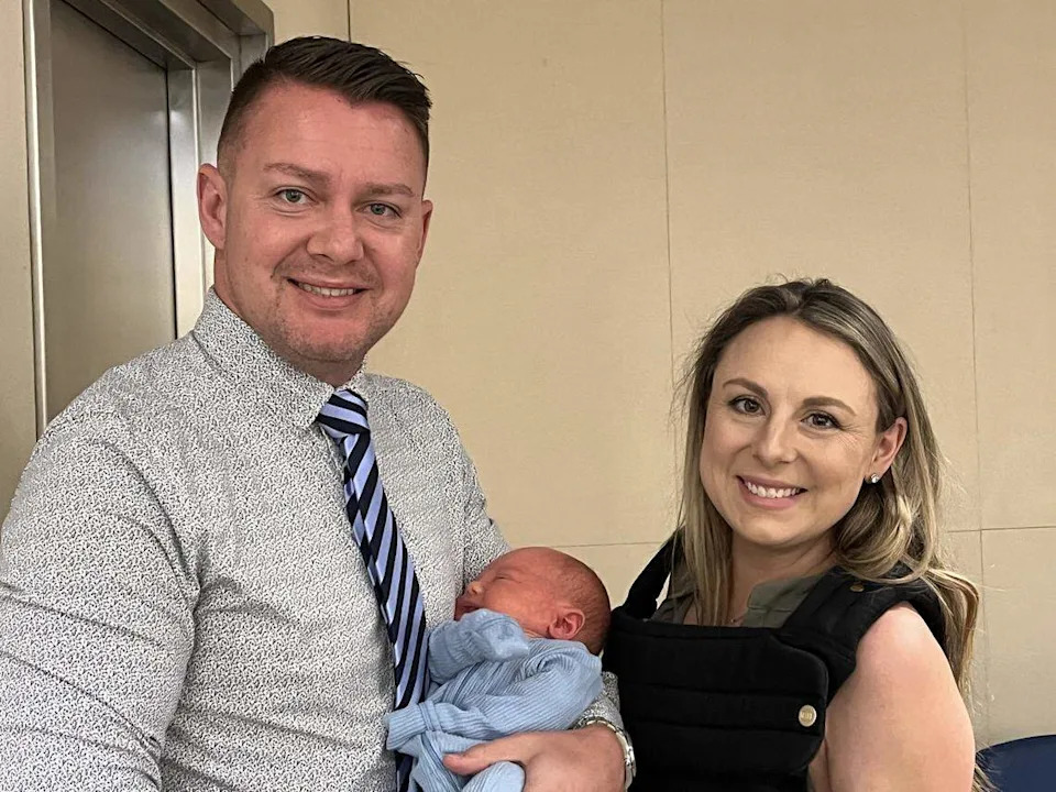 Fresno City Councilmember Nick Richardson, left, and wife Kelsey Richardson show off baby Teddy at the June 4, 2026 council meeting.