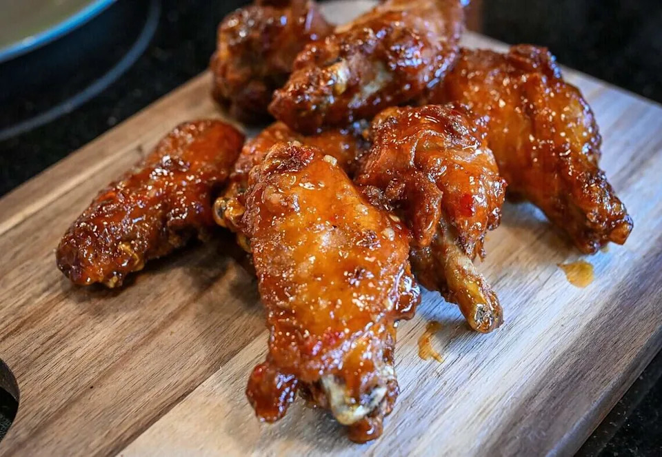 Sweet chili wings are ready to devour at The Curry Pizza Company's newest location on Fowler Avenue, southeast of Belmont Avenue in Fresno. This location is the first to have a full bar.