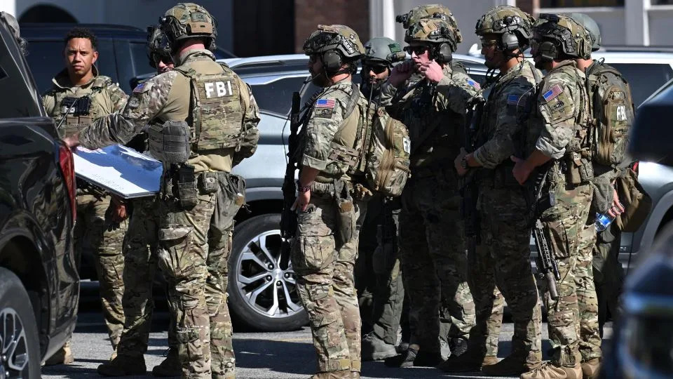 FBI agents respond after a man barricaded himself inside a building containing school district offices on Tuesday in Bakersfield, California. - David Dennis/AP