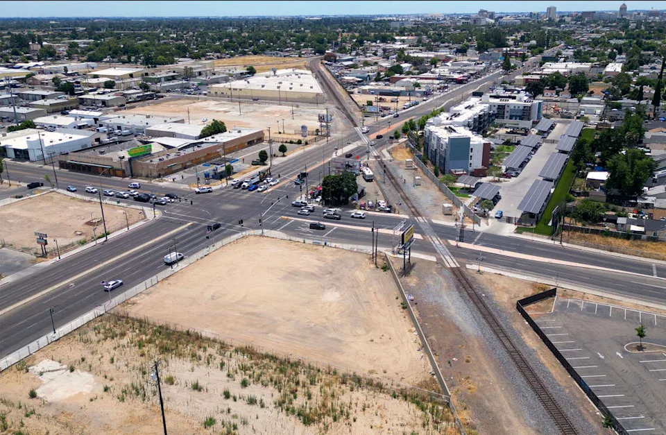 Cleared land is seen a the bottom center where a Carl’s Jr. burned in January 2026, photographed Monday, June 8, 2026 in Fresno. The intersection of Blackstone and McKinley avenues with intersecting railroad is shown. The city has purchased most of the land around the intersection so it can lower the street as much as 25 feet to avoid traffic backups when trains cross.