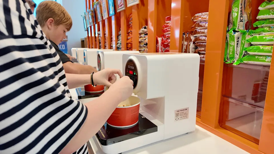Customers try on the ramen station at Sakura Market’s soft opening on June 24.