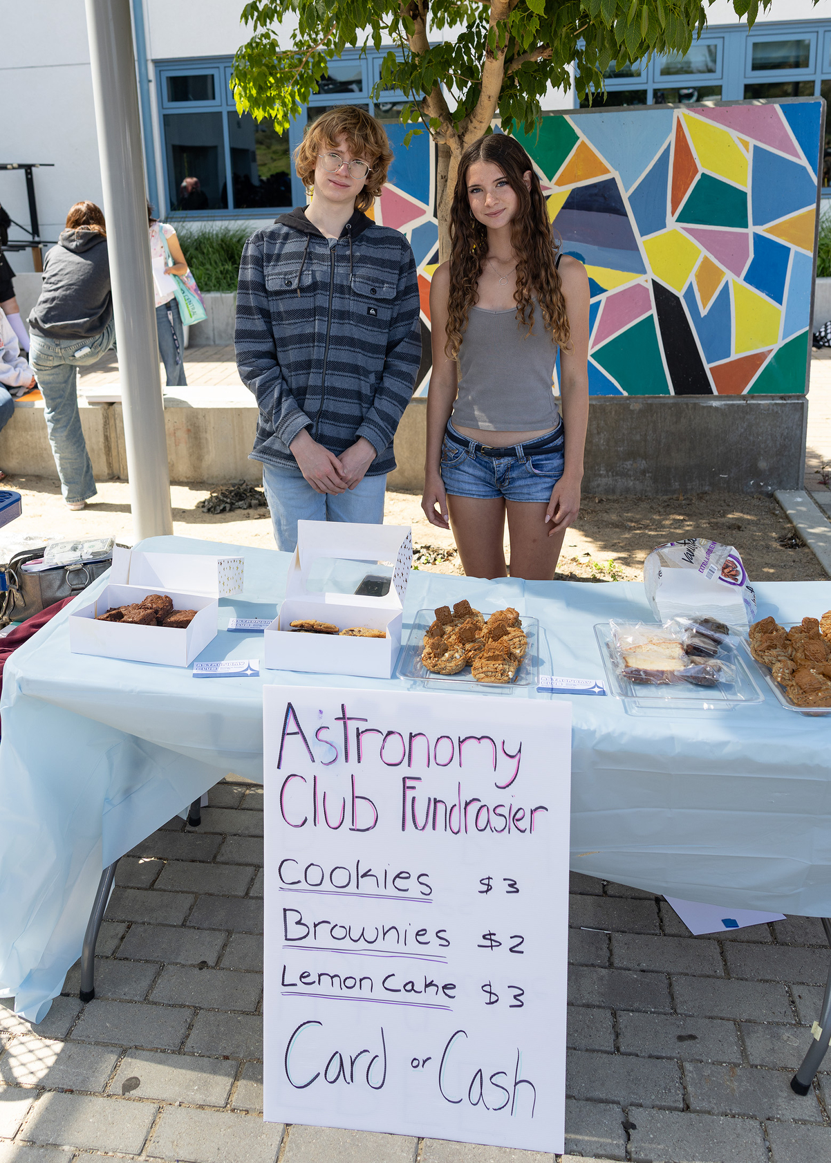 Devin Sanders and Luca Lamoureux sell baked goods to support...