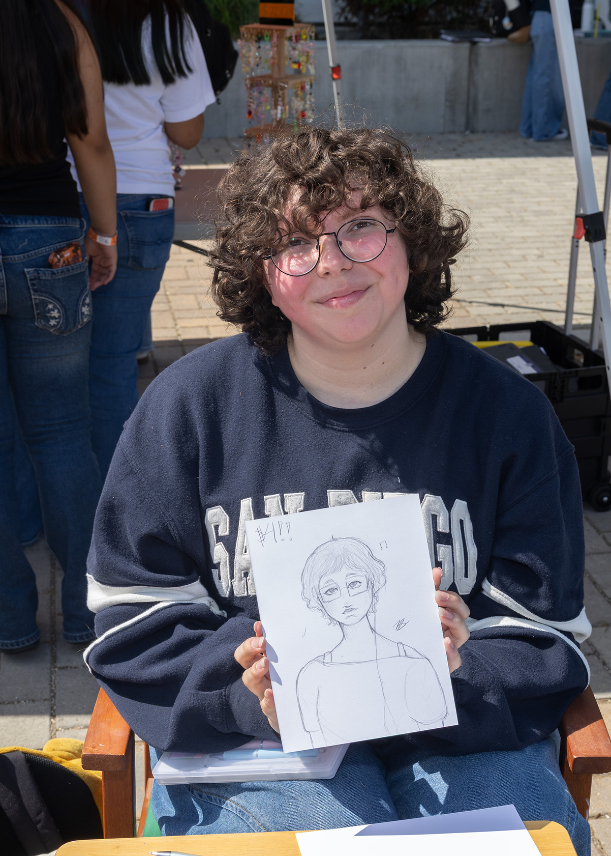 Blake Burrows sketched people’s portraits at the event. (Jon Clark)