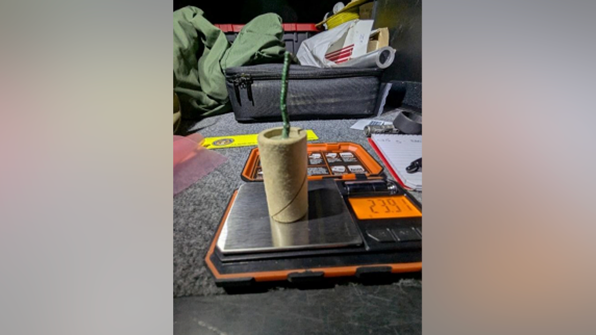 Improvised explosive device with a green fuse sitting on a digital scale as shown in federal court documents