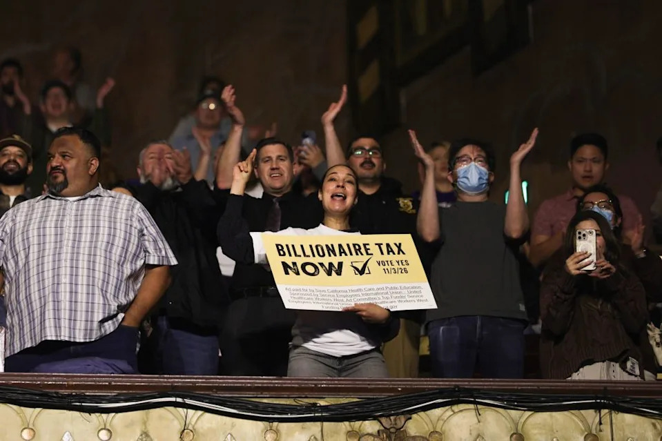 Attendees cheer as US guitarist Tom Morello performs during the Billionaire Tax Now rally at the Wiltern Theater in Los Angeles. CHRIS TORRES/EPA/Shutterstock