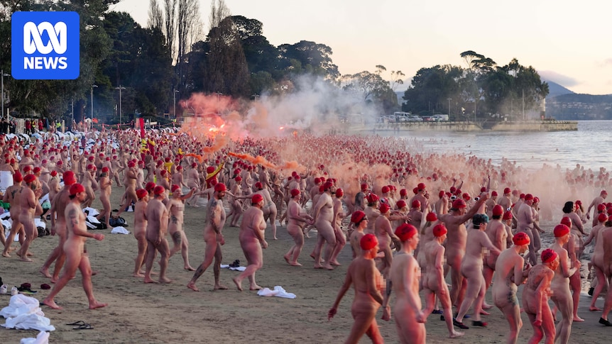 Nude swimmers take chilly plunge in Dark Mofo solstice swim