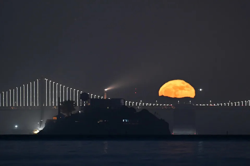 The view of the moon rising over the Bay Bridge of San Francisco, as seen from Sausalito. Anadolu via Getty Images