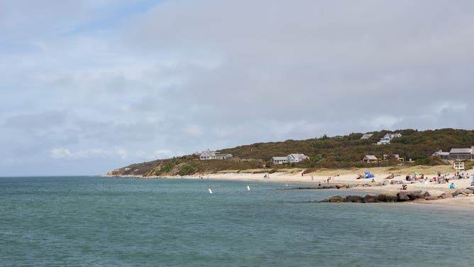 People on a beach near the small fishing community of Menemsha on MarthaÕs Vineyard, Massachusetts, USA.
