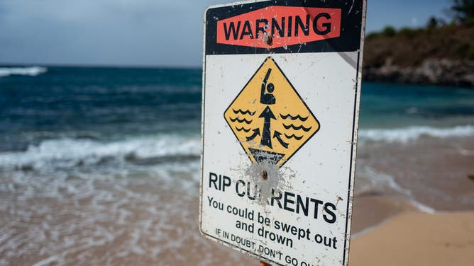 Sign warning swimmers of dangerous rip currents and wave conditions, Ho'okipa Beach, Maui, Paia, Hawaii, July 18, 2023.