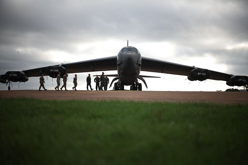 Flight crew from US Air Force 501st Combat Support Wing and 307th Bomb Wing walk toward a B-52 Stratofortress bomber aircraft at RAF Fairford on September 19, 2025.