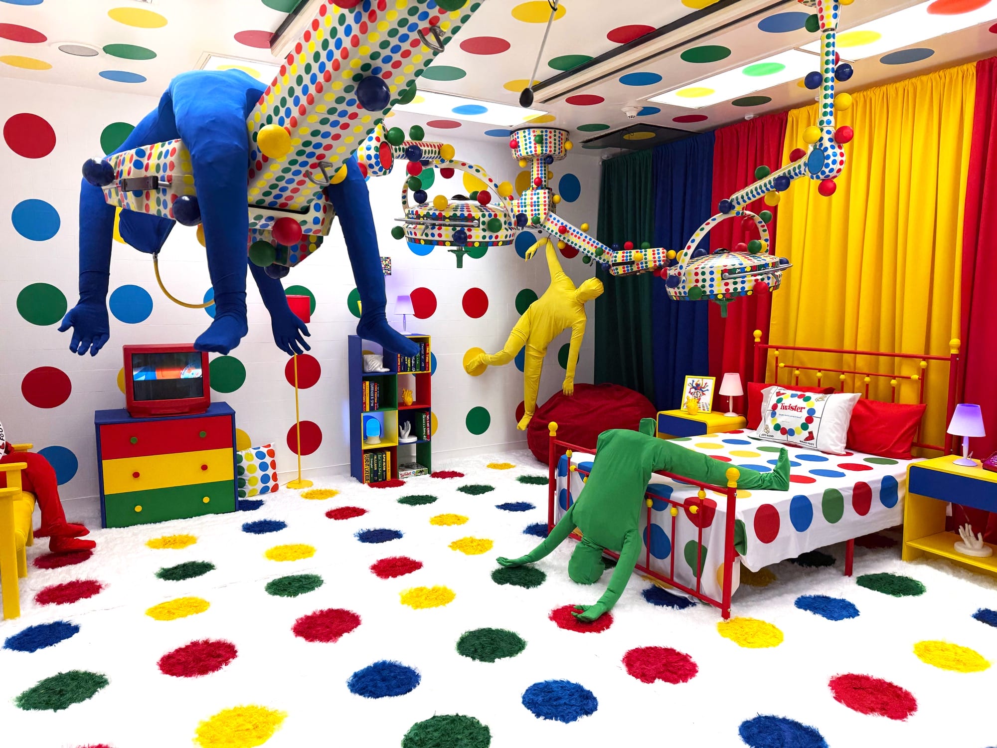 a hospital room installation transformed by Twister dots and contorted figures