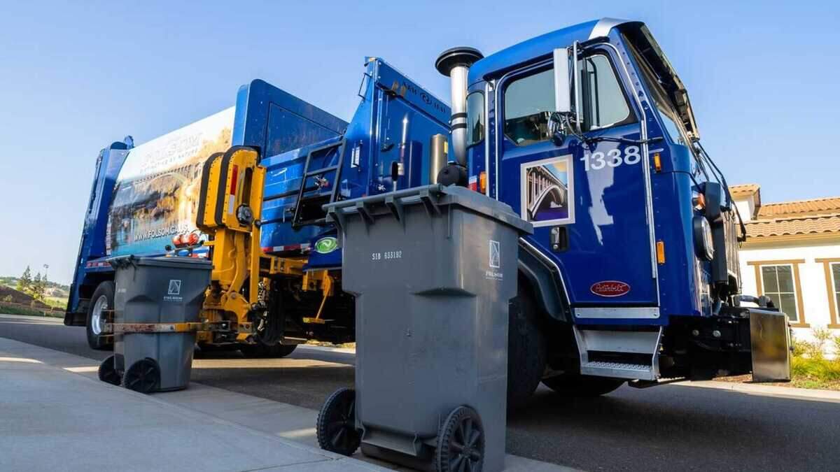 A Folsom garbage truck collects trash along a residential street in Folsom in 2024.