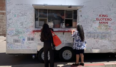 Two customers order from the King Elotero Man food truck during the Fresno Area Hispanic Foundation’s Mobile Food Vendor Grant Ceremony in downtown Fresno.