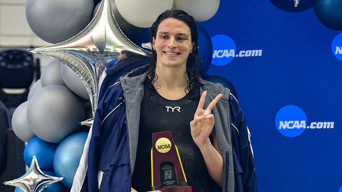 University of Pennsylvania swimmer Lia Thomas holding winning trophy at swimming championship