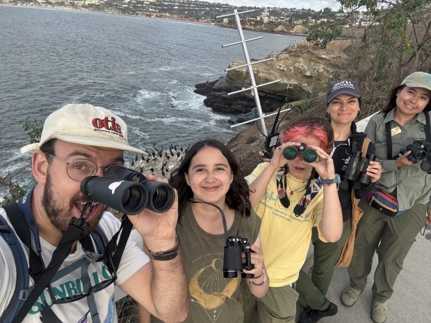 Scripps Institution of Oceanography graduate student Alex Rubenstein (left) gathers with the citizen scientists who are helping with his work to collect baseline information about seabirds around La Jolla Cove. (Provided by Alex Rubenstein)