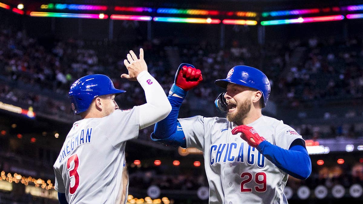 Michael Busch congratulated by Alex Bregman after hitting a home run at Oracle Park