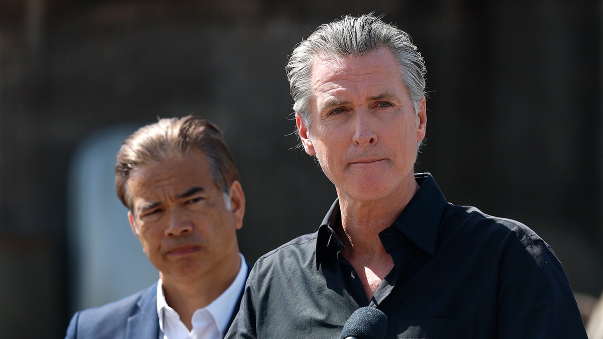 California Governor Gavin Newsom and Attorney General Rob Bonta standing at a news conference outdoors