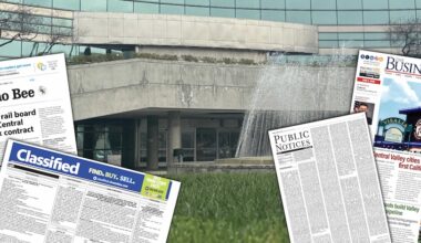 a city hall with newspaper issues in front