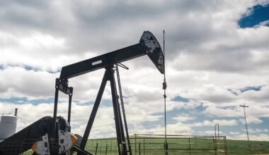 Image of an oil well under a cloudy blue sky