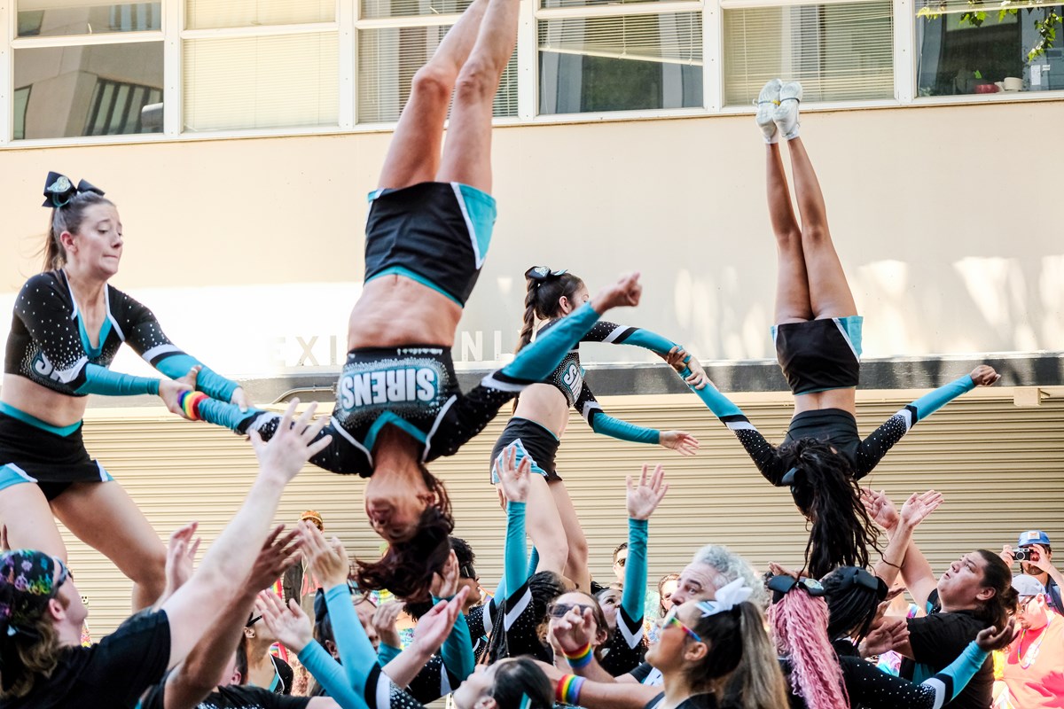 The Sacramento Sirens Cheer Elite tossing squad members at the Sacramento Pride March on Sunday, June 15 2026.