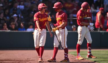 Walter Urbon high-fives teammates in the dugout after hitting a grand slam against Lamar