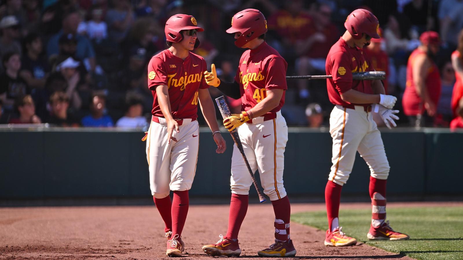 Walter Urbon high-fives teammates in the dugout after hitting a grand slam against Lamar
