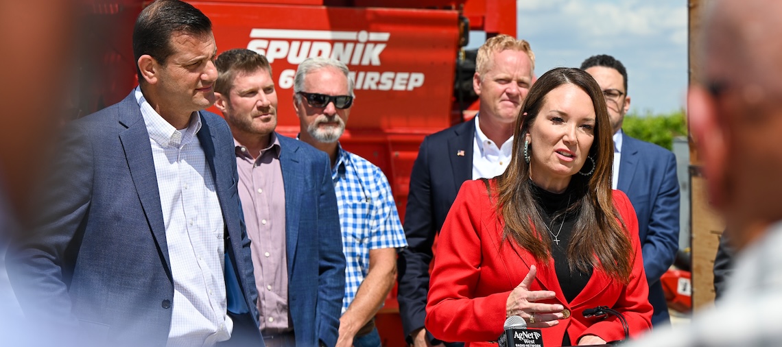 woman speaks at podium