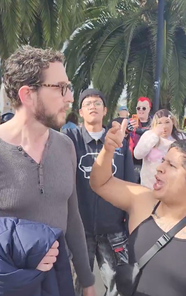 People protesting and shouting at Scott Wiener.