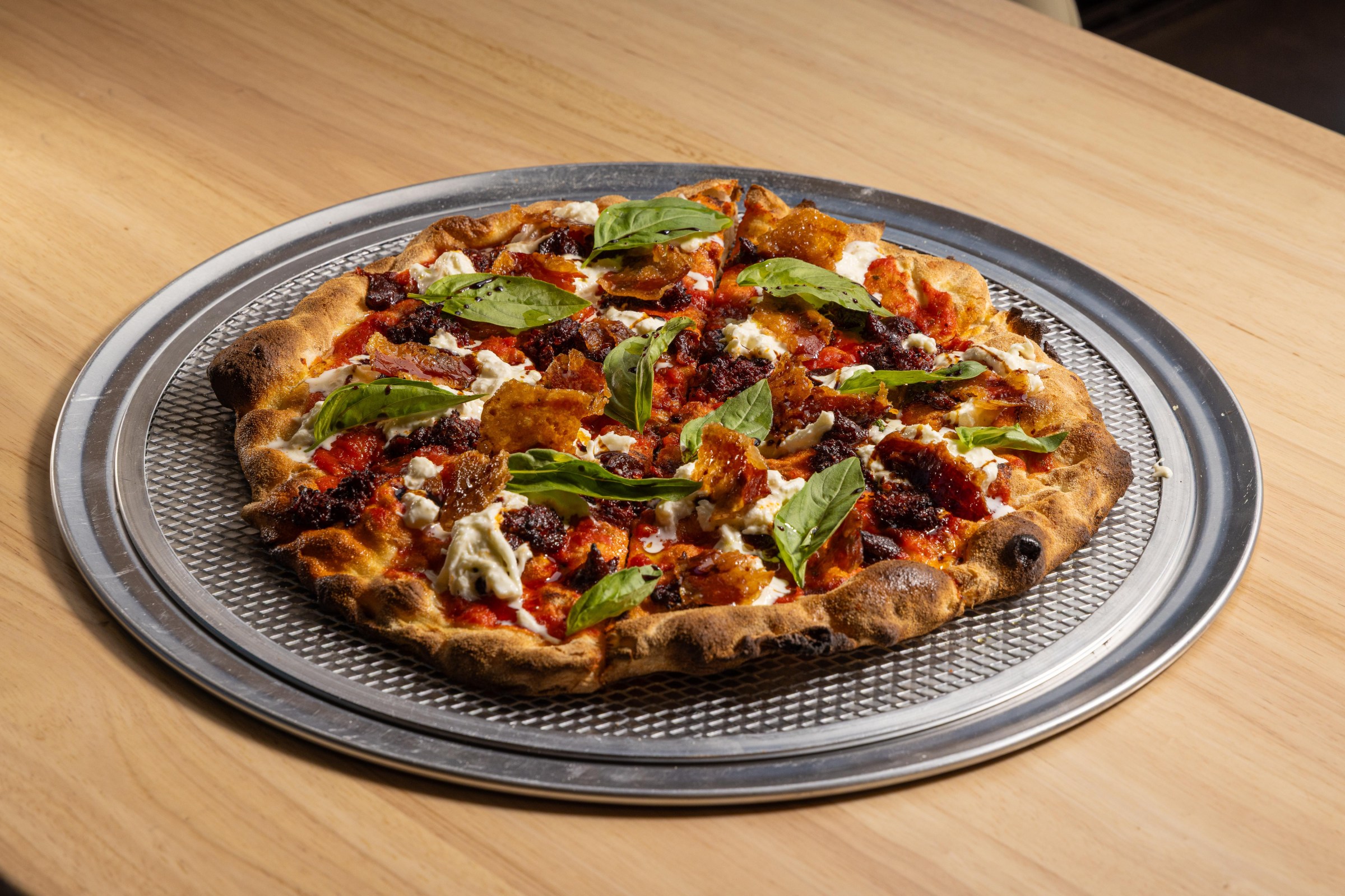 Thin, crispy pizza scrocchiarella with gochujang romesco at Pizzeria Sei.