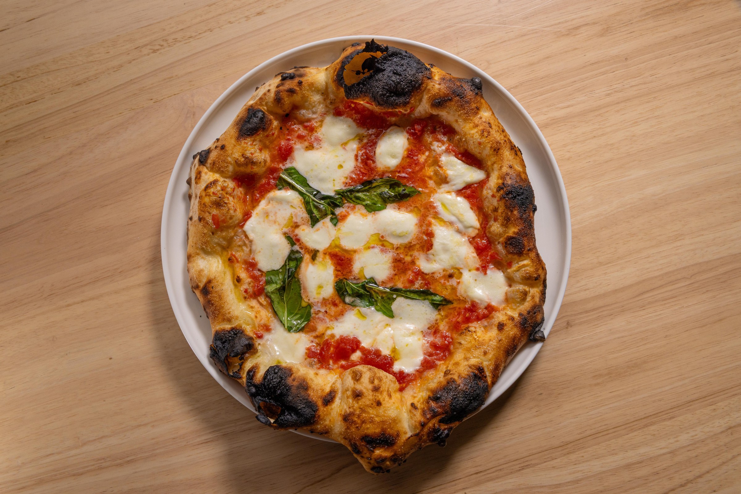 Overhead shot of a Neapolitan margherita pizza at Pizzeria Sei.